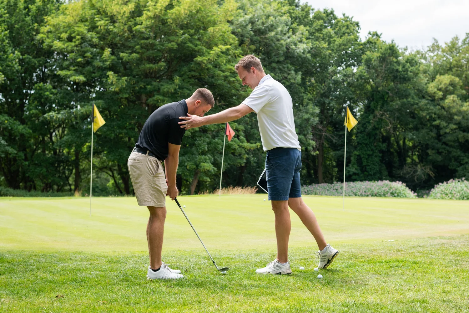 PGA coach teaching a group golf lesson